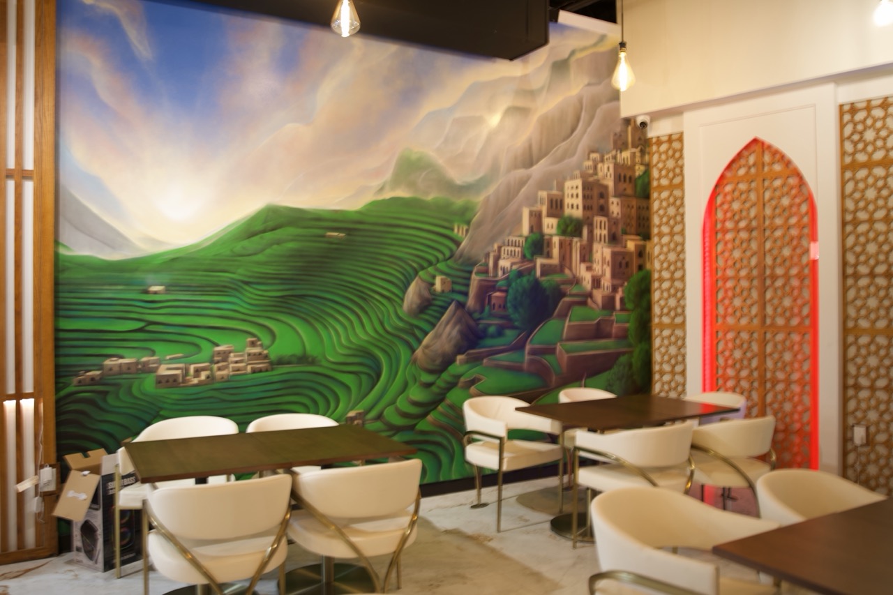 Mural of a green terraced Yemeni mountain village