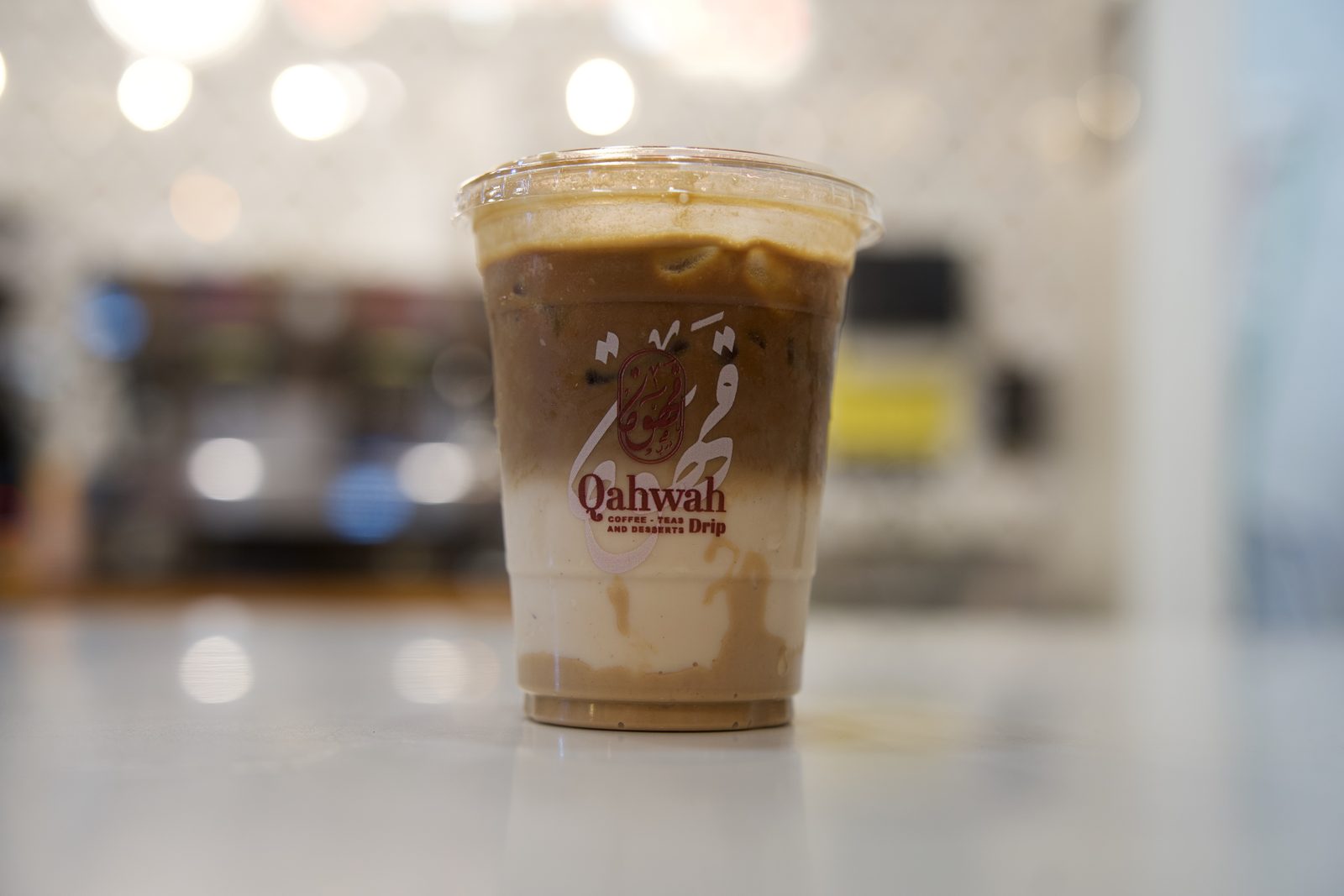 Iced Yemeni latte in a Qahwah Drip cup at the espresso bar