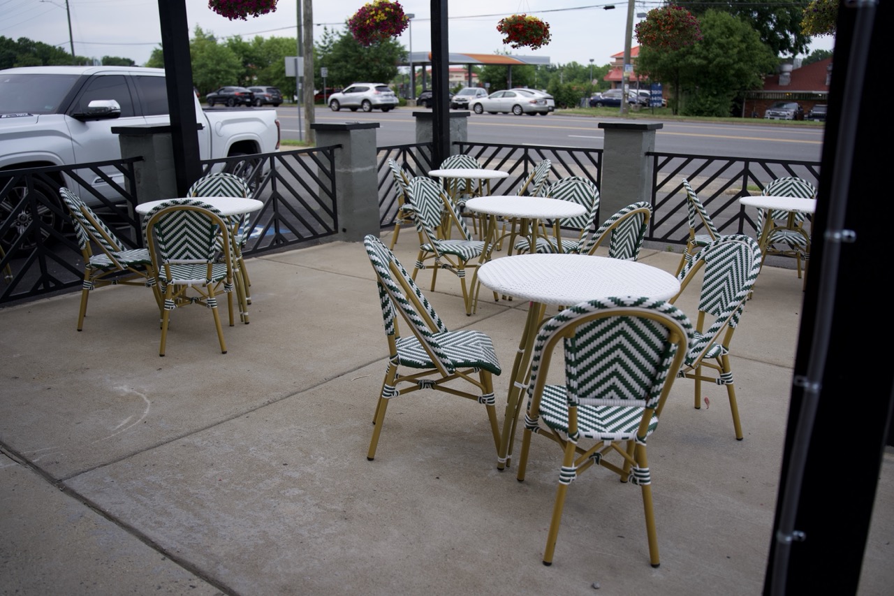 Qahwah Drip patio with green-and-white bistro seating